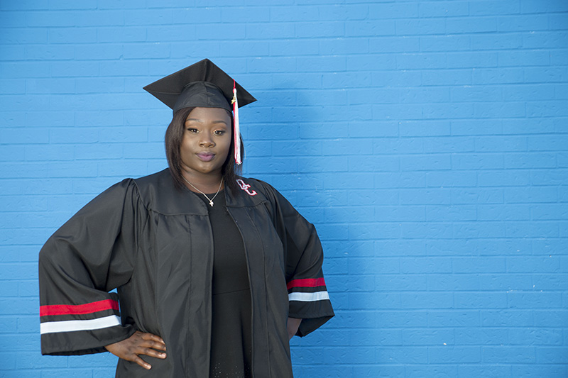 senior posing in cap and gown for graduation photography